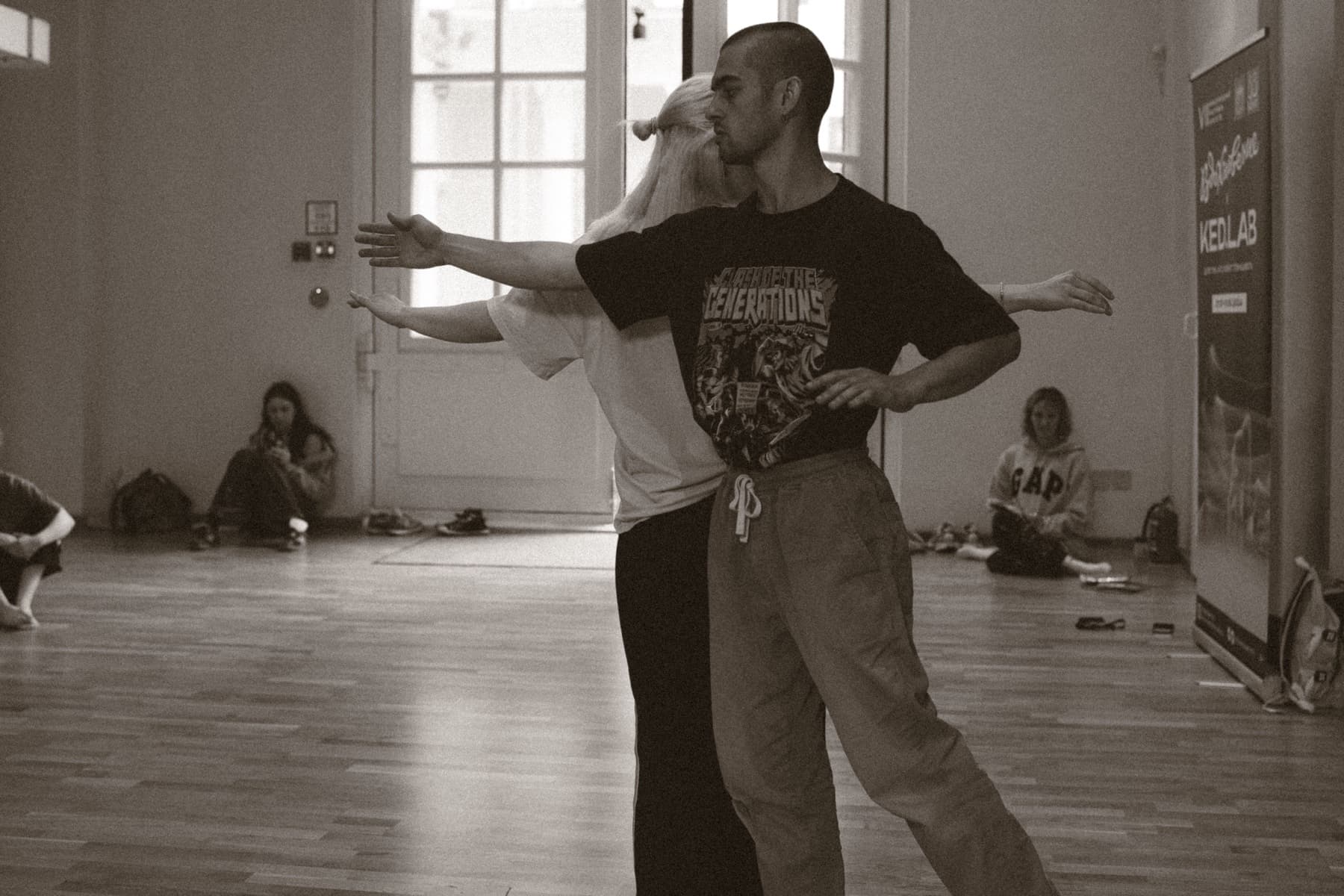 A performer extends his arm as other dancers echo the gesture behind him during the Green Theatre laboratory.