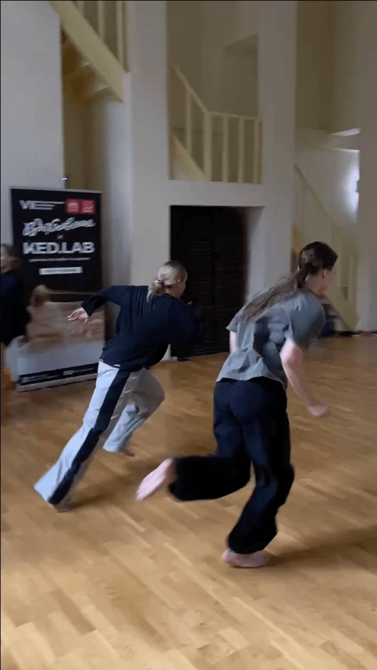 Two participants run through the studio during the Green Theatre laboratory.