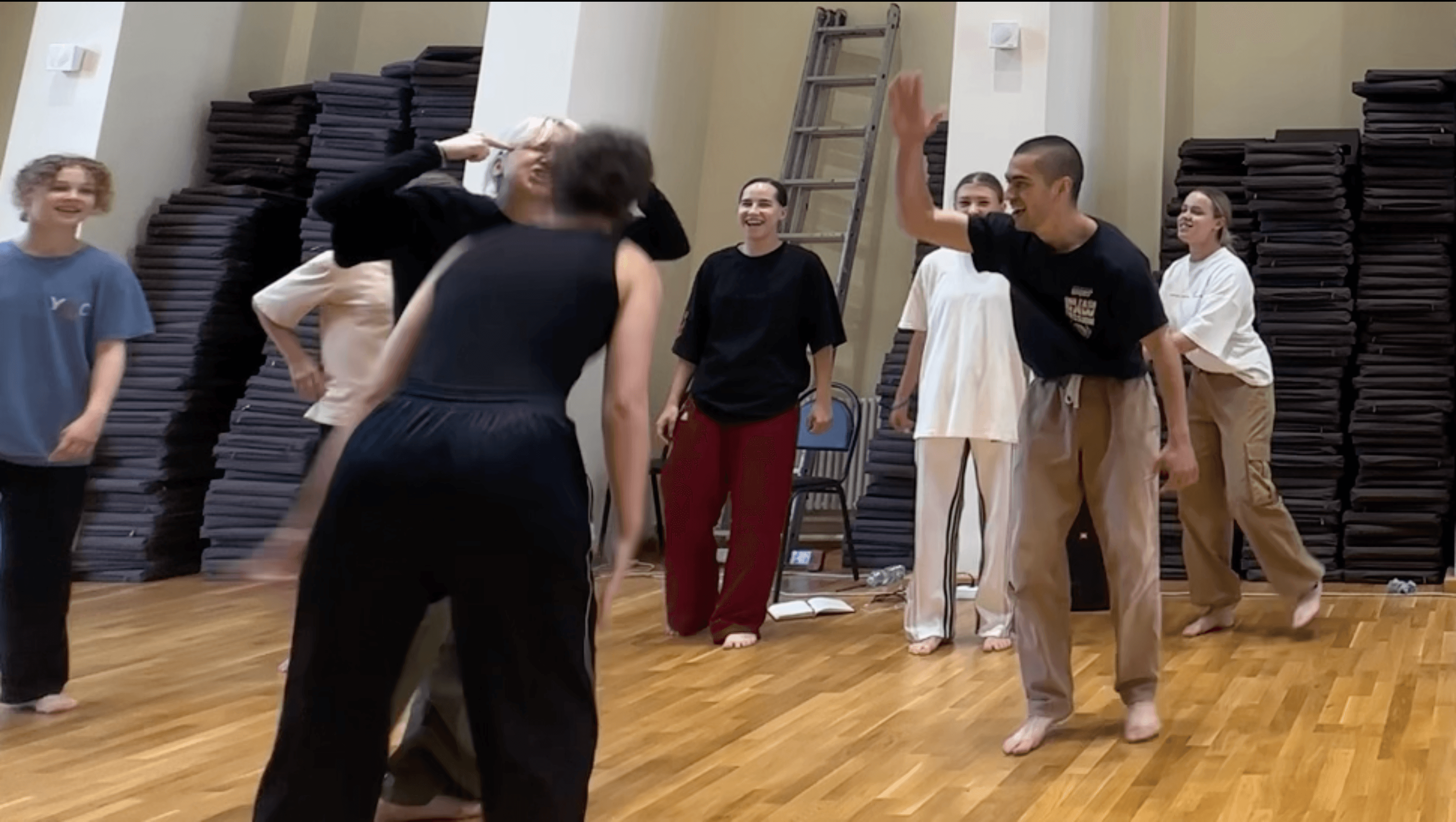 Participants share a playful movement exchange during the Green Theatre laboratory.
