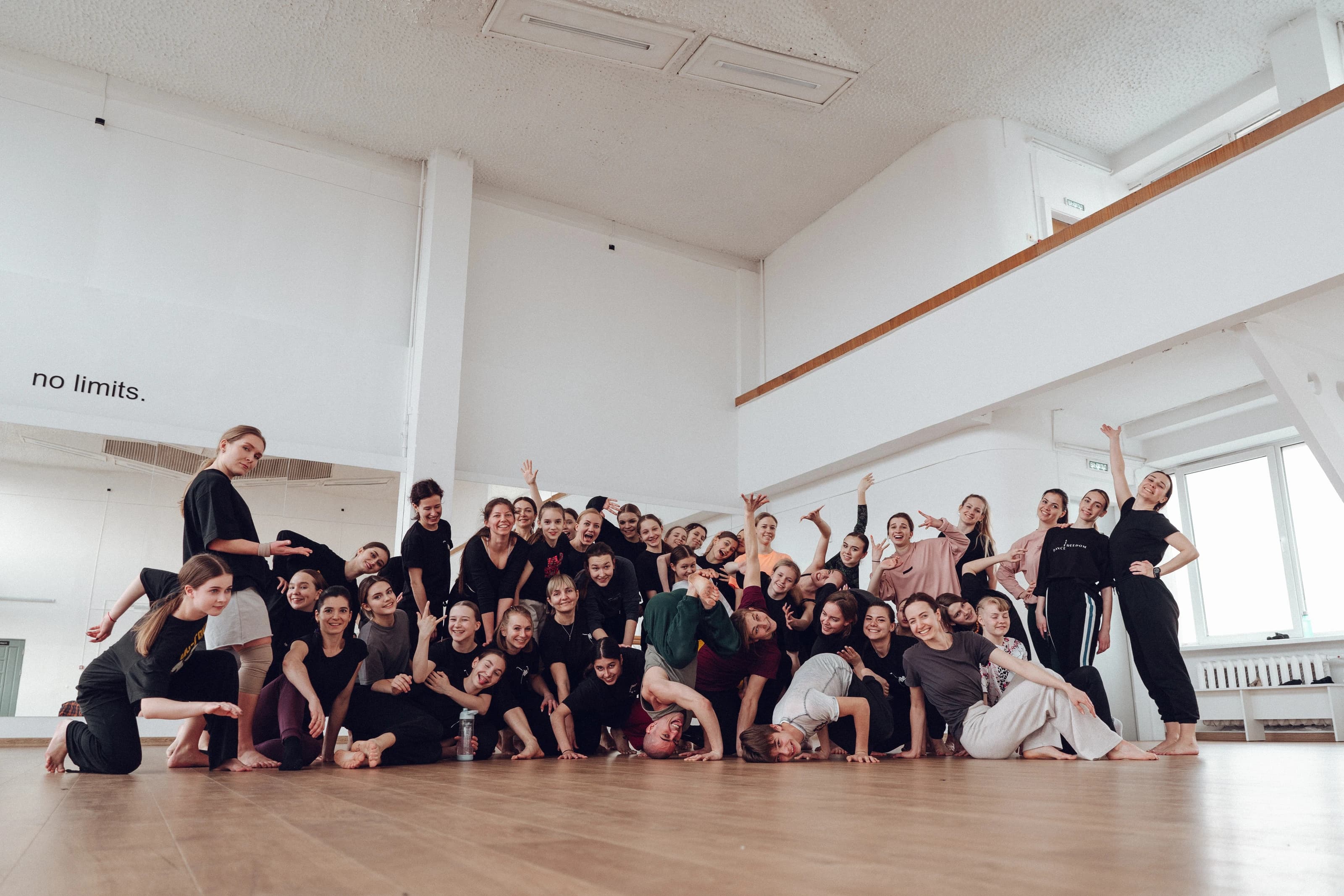 Workshop participants posing together in a bright studio.