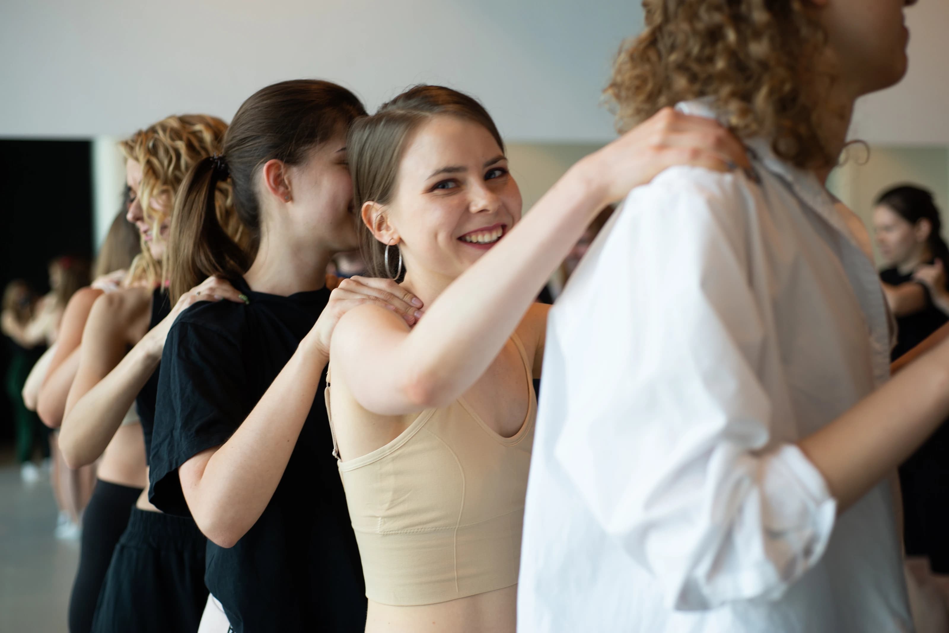 Participants connect through touch during a workshop.