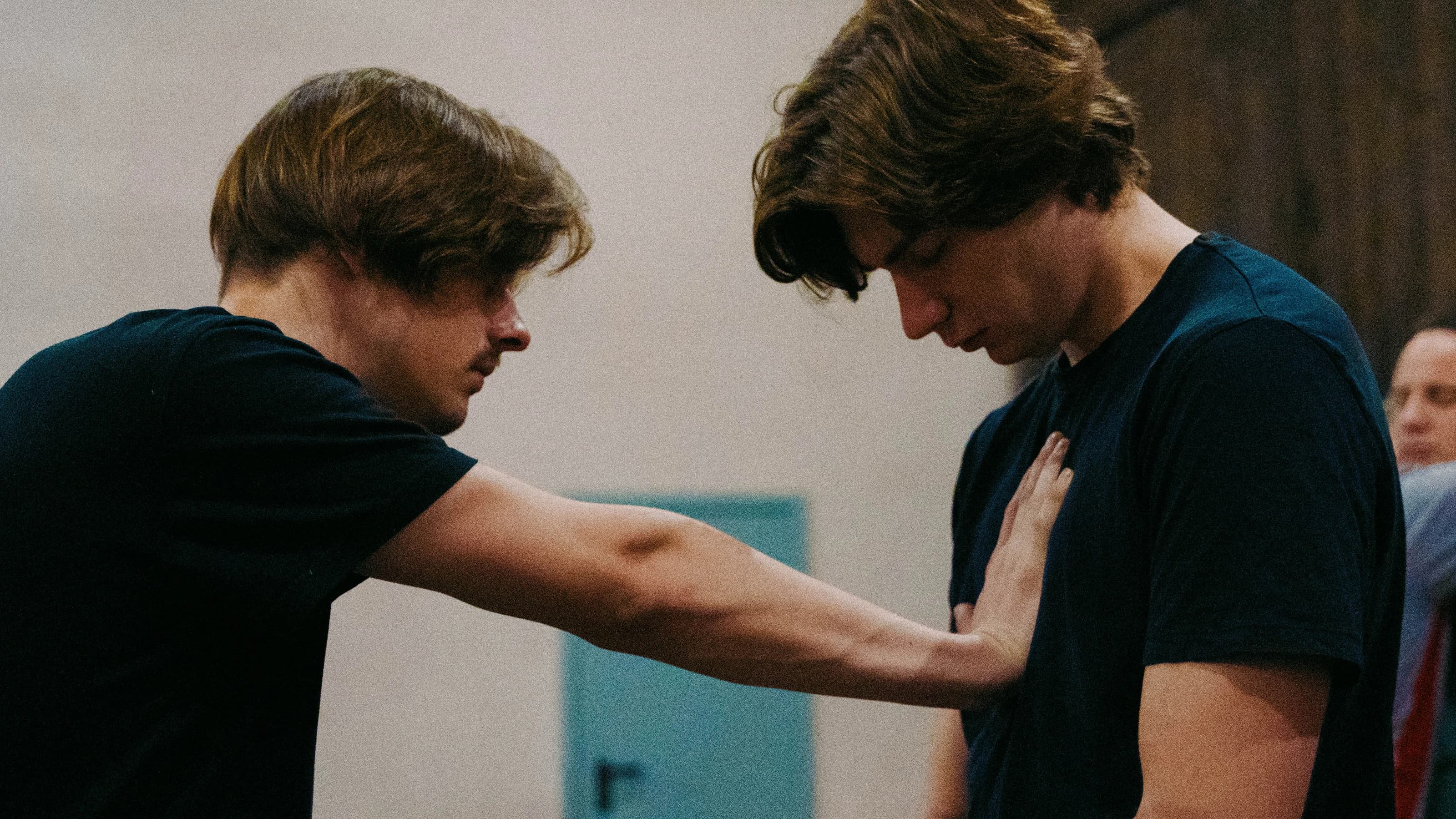 Two participants explore contact through a hand placed on the chest.