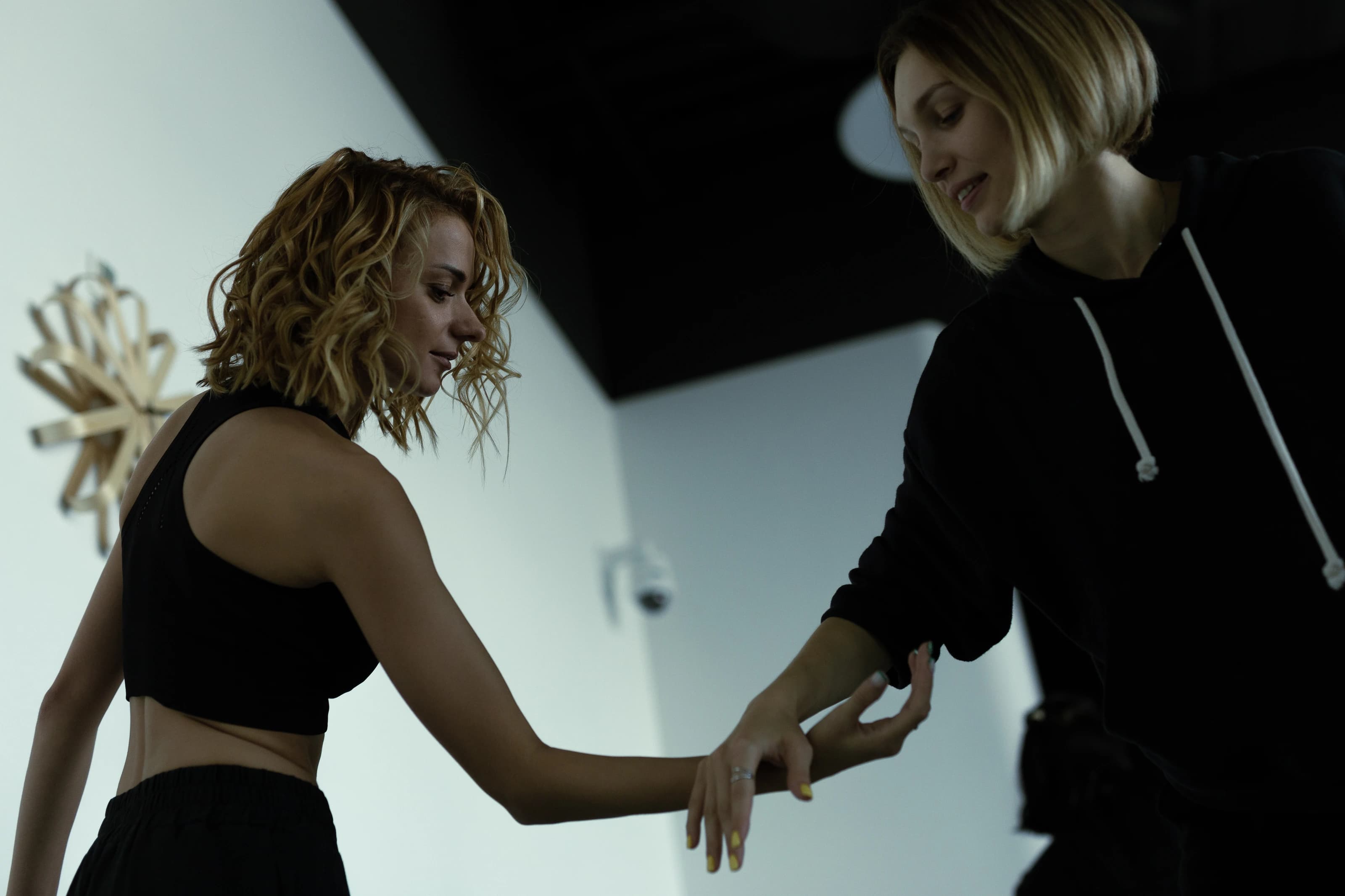 Two participants explore touch and movement through their hands.