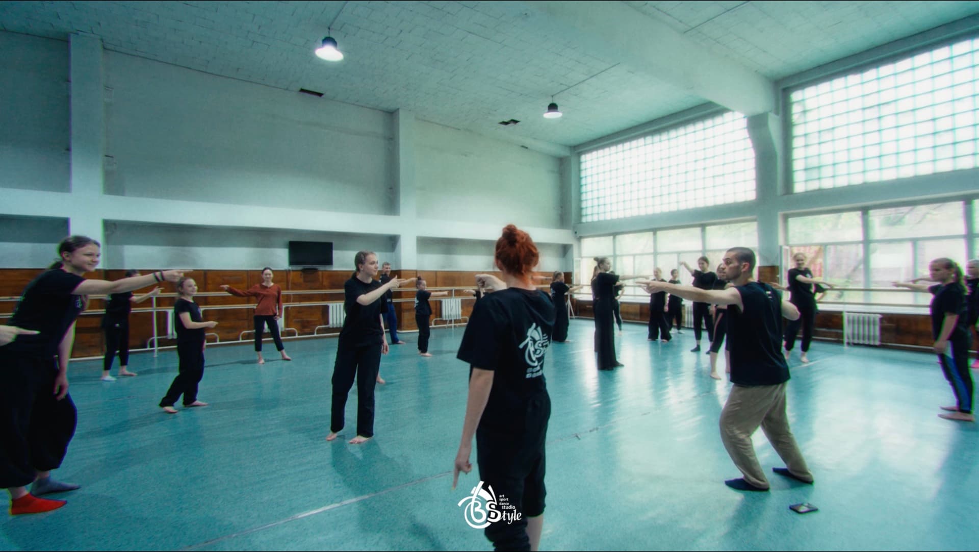 Workshop participants exploring movement together in a bright dance studio.