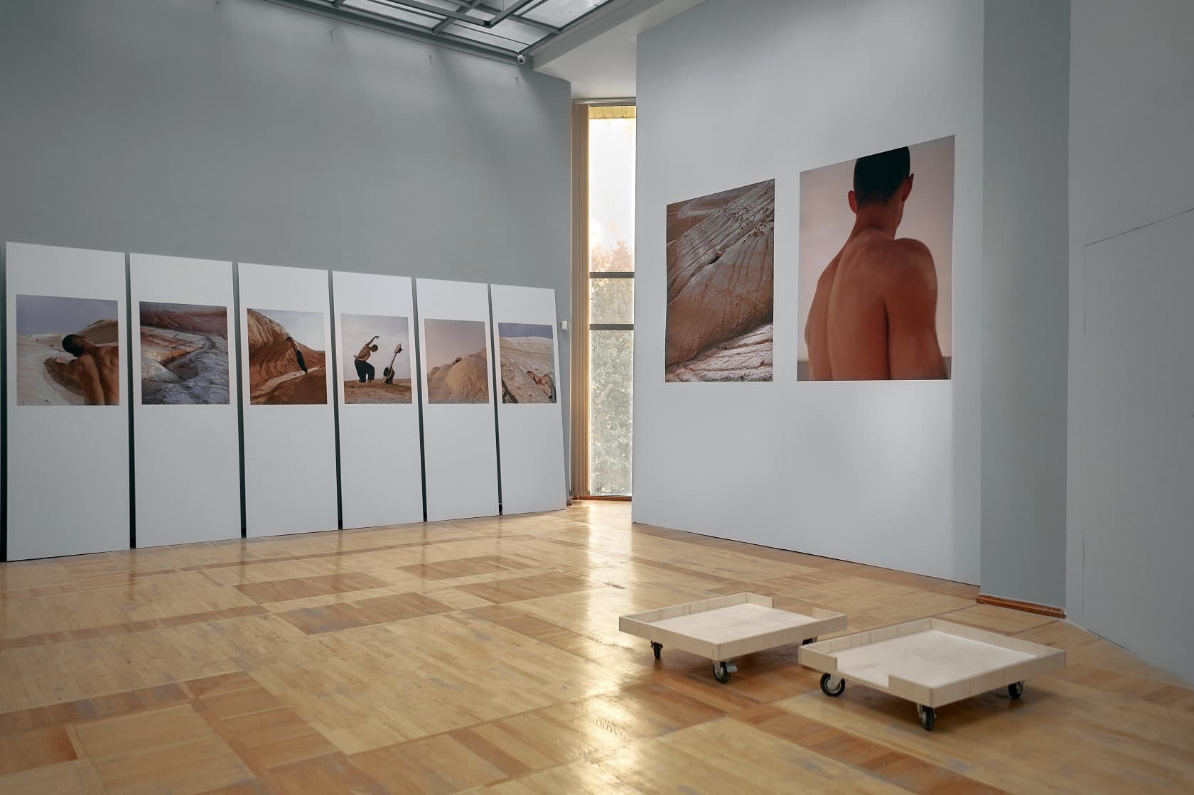 Rhythm of the Steppe photographs installed across two walls of a gallery in Almaty.