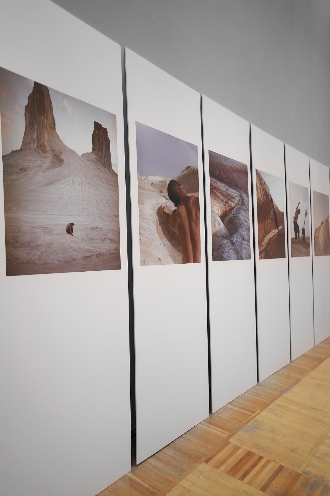 Rhythm of the Steppe photographs displayed on freestanding panels in an Almaty gallery.