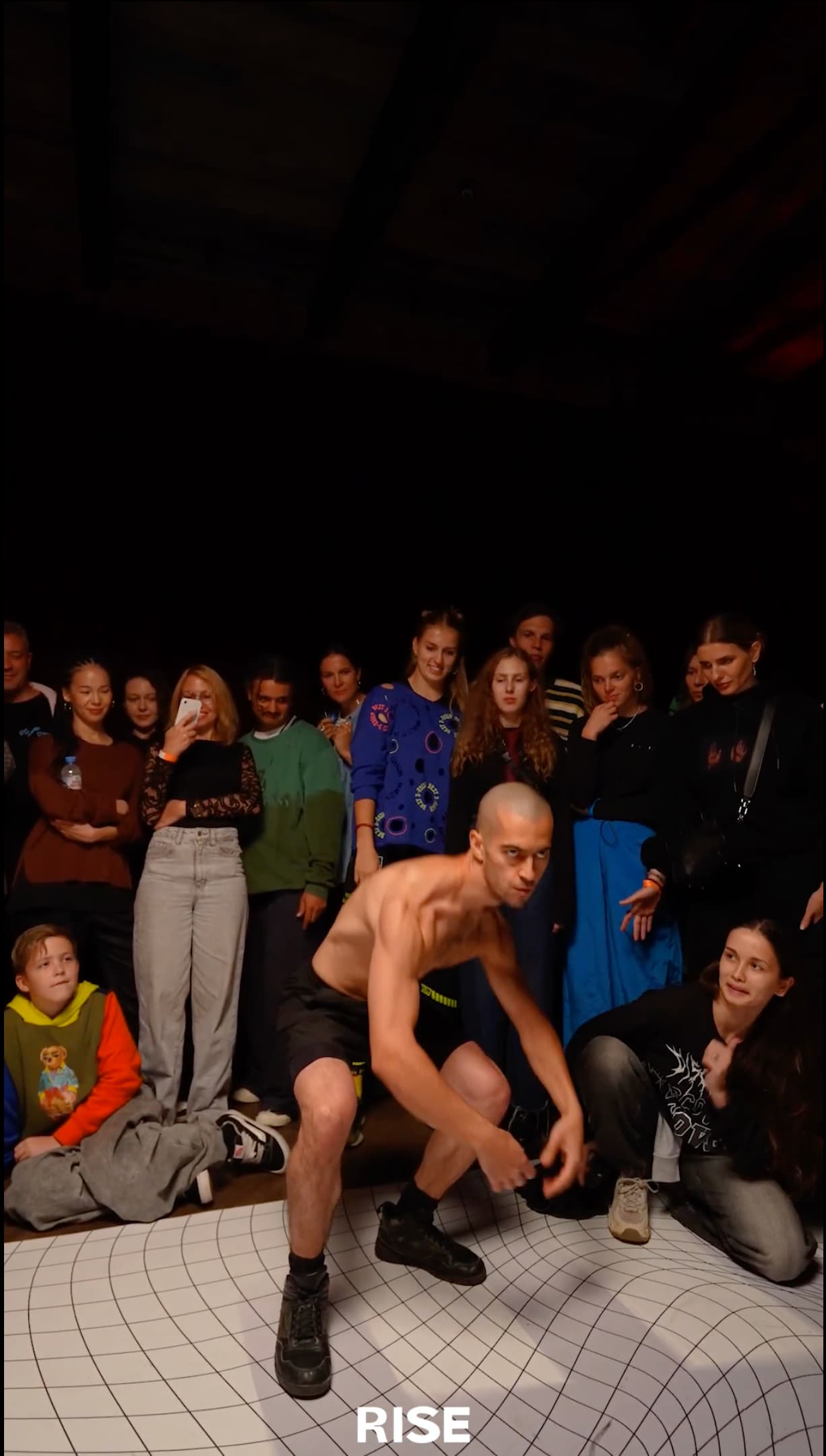 Kolya Bagdasaryan performing at an experimental dance battle surrounded by spectators.