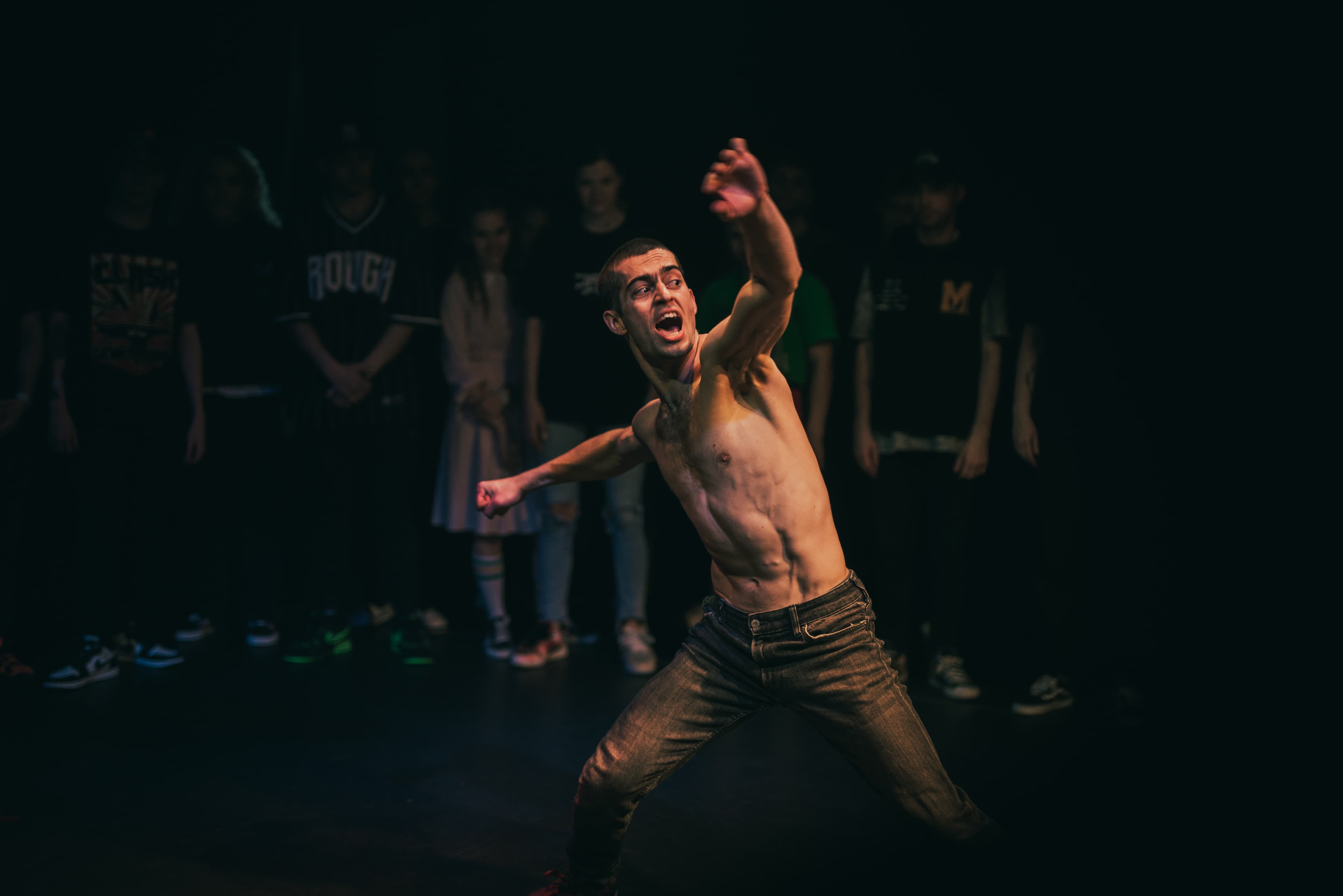 Kolya Bagdasaryan performing at a national krump festival as the audience watches.