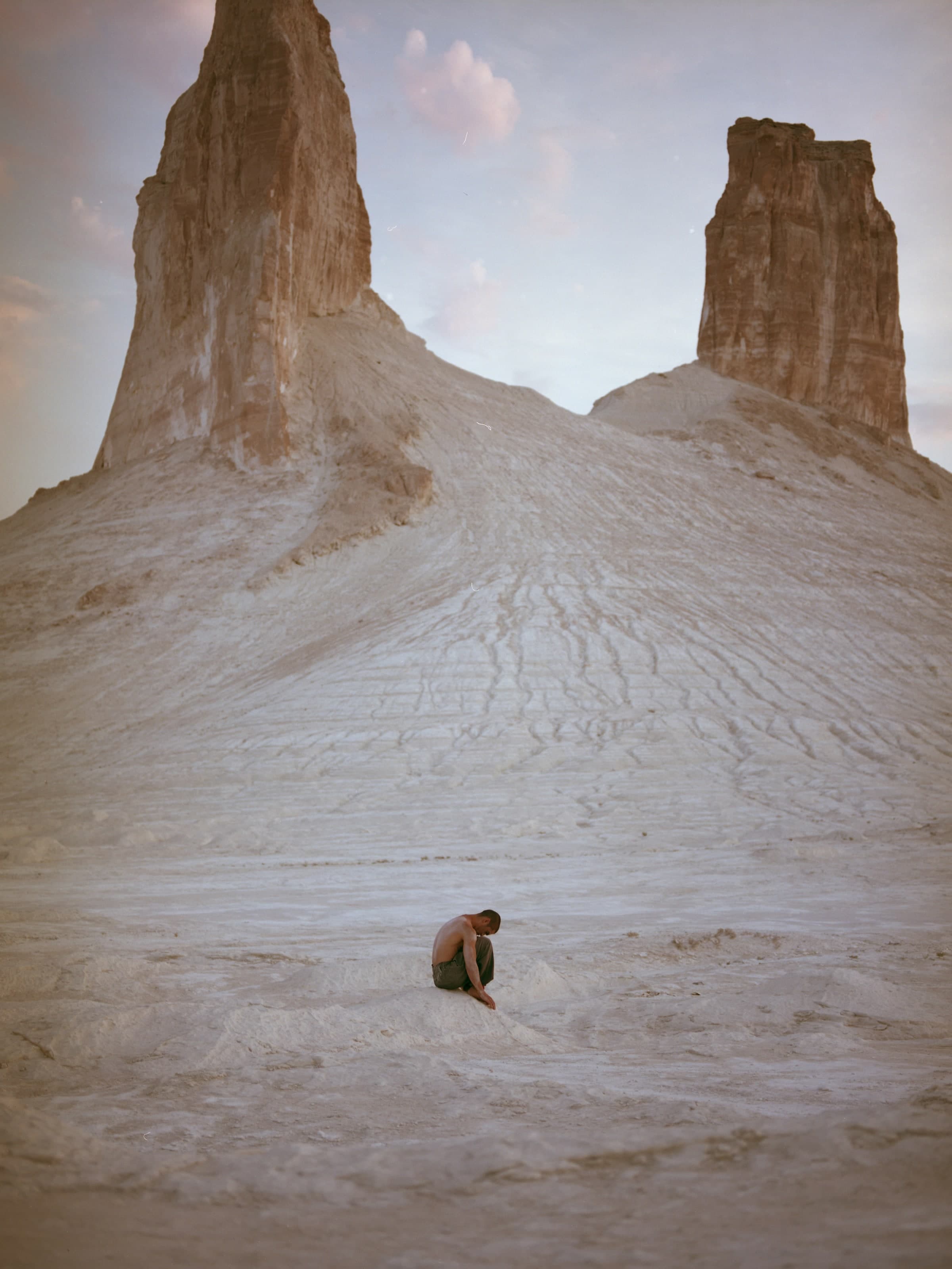 Kolya Bagdasaryan seated between the rock formations of Bozzhyra.