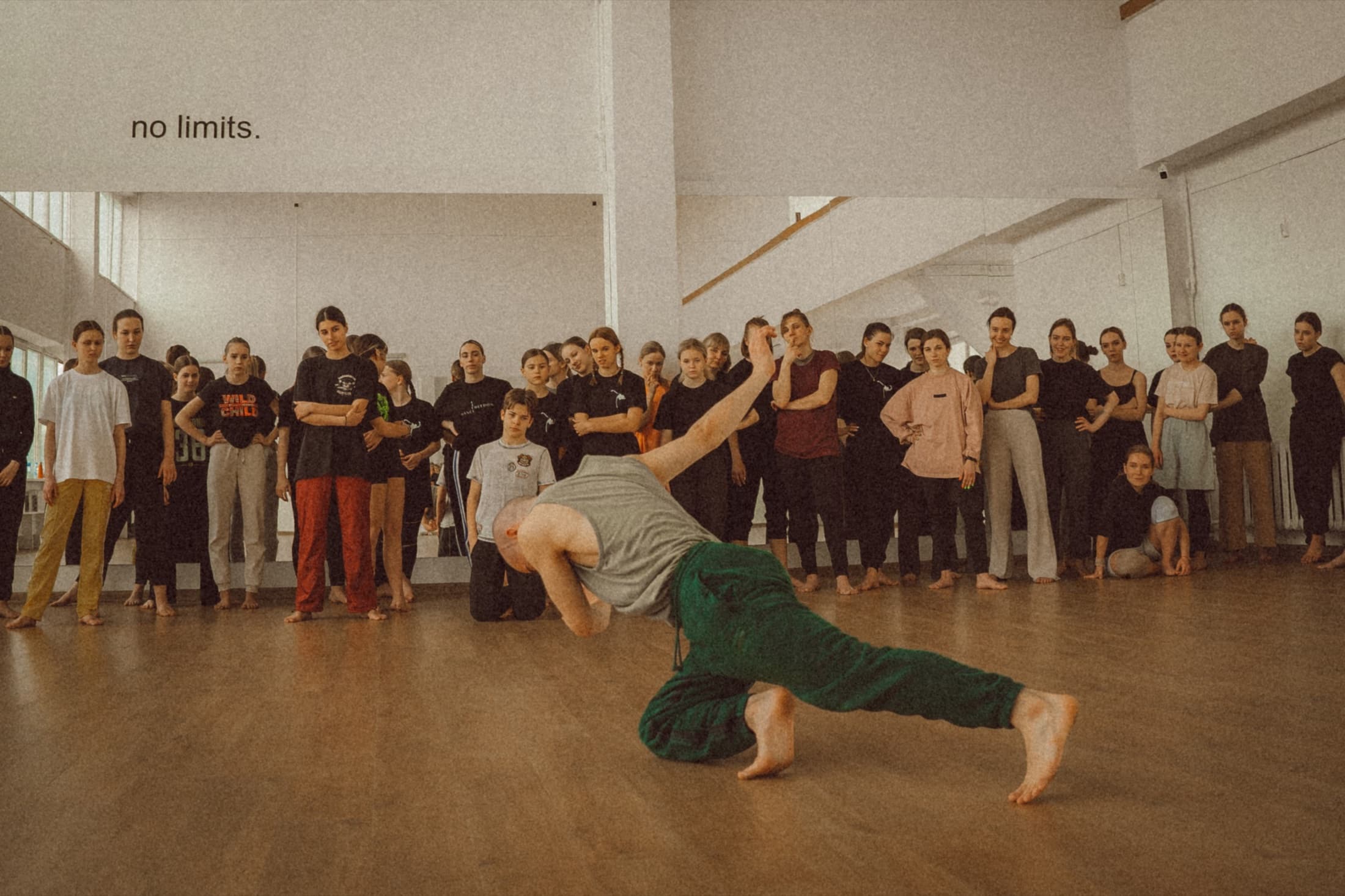 A facilitator moves on the studio floor while workshop participants observe.