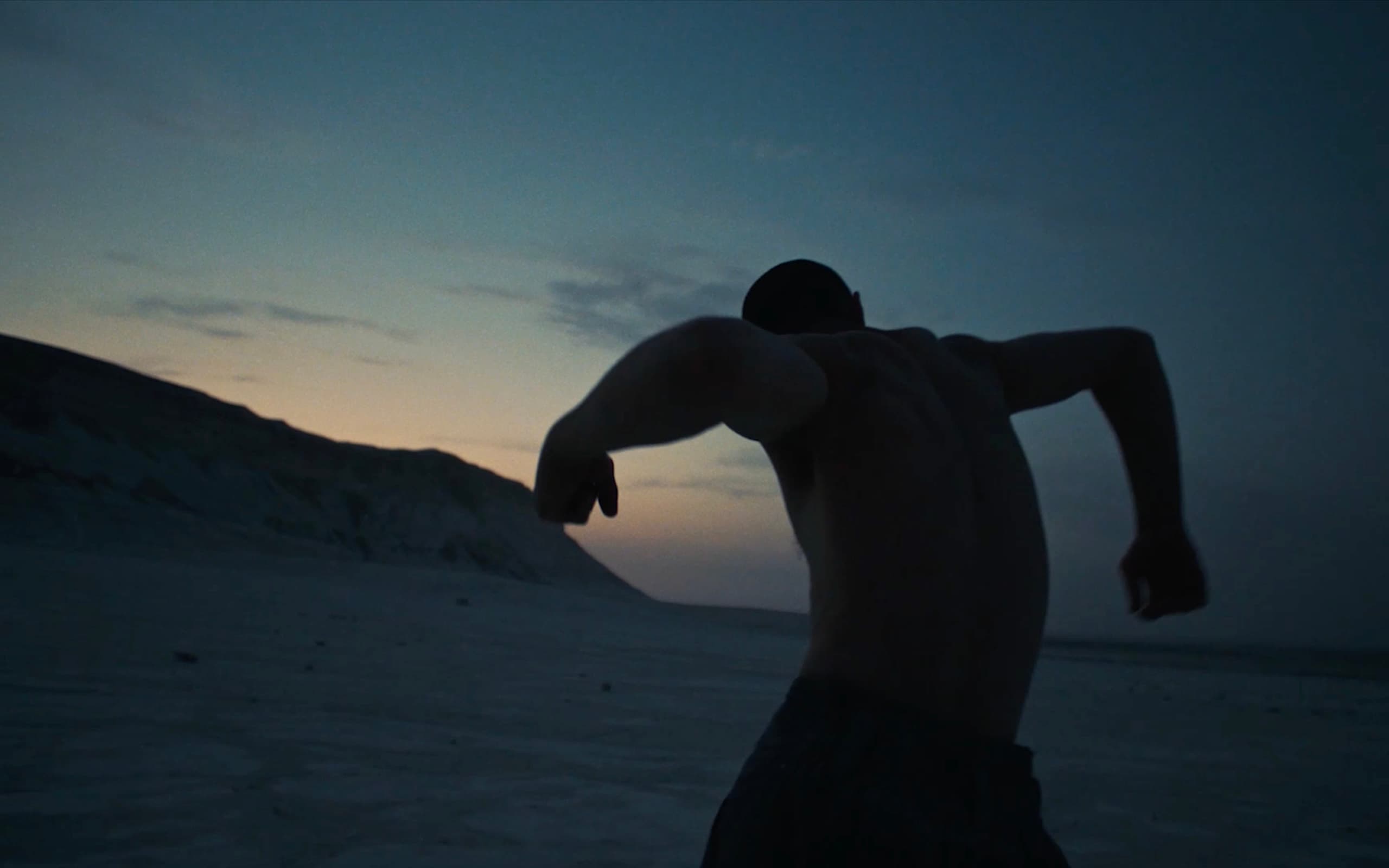 Kolya Bagdasaryan moving in silhouette against the dusk sky at Bozzhyra.