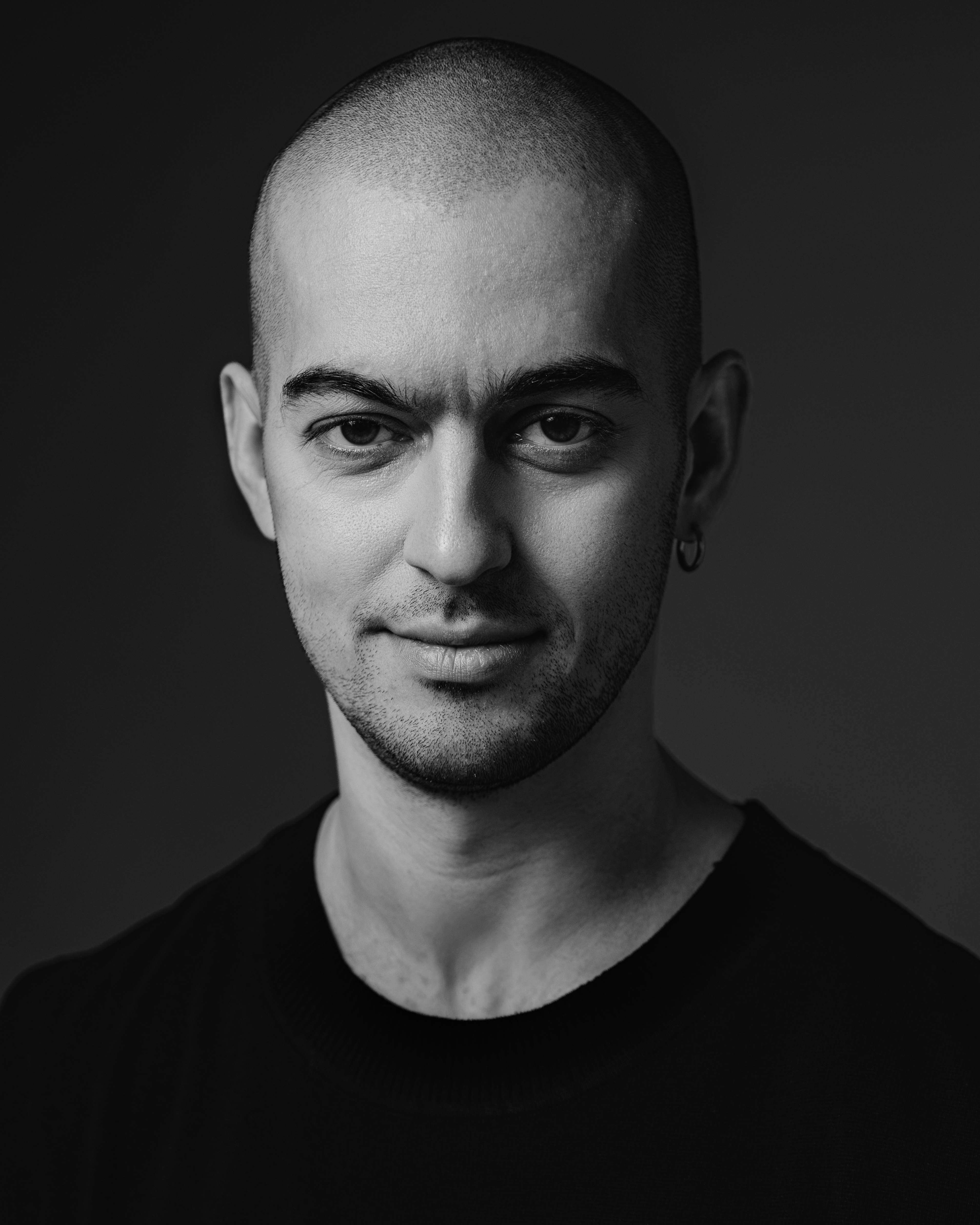Black-and-white portrait of Nikolay Bagdasaryan looking directly at the camera.